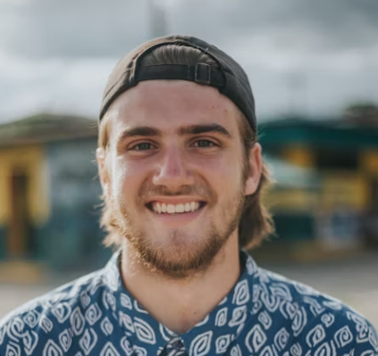 Man in cap smiling outdoors